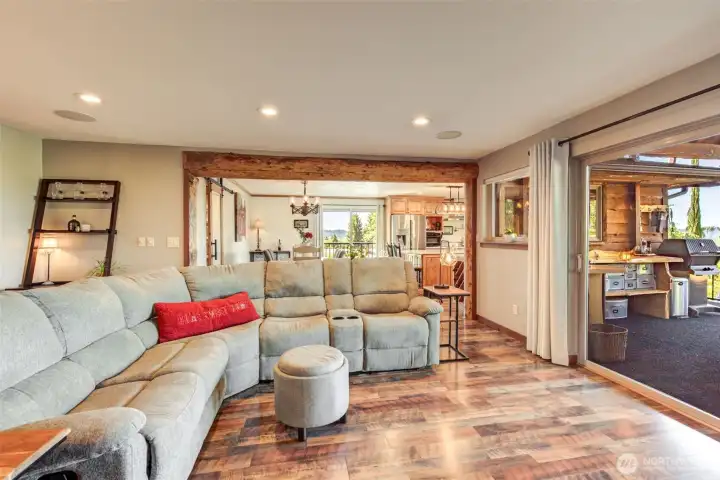 The living room offers true indoor-outdoor ease with access to the covered barbecue and entertainment area.