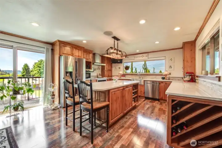 Custom chef's kitchen with extensive storage, oversized island seating, and gorgeous views from every angle.
