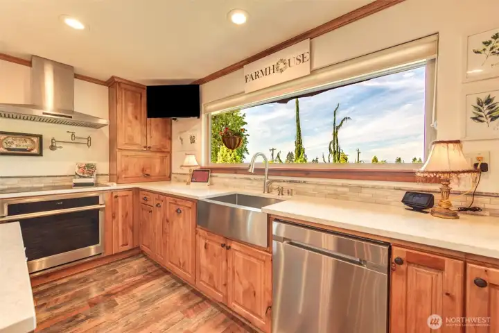 Prepare meals while taking in sweeping views from the oversized picture window above the farmhouse sink.