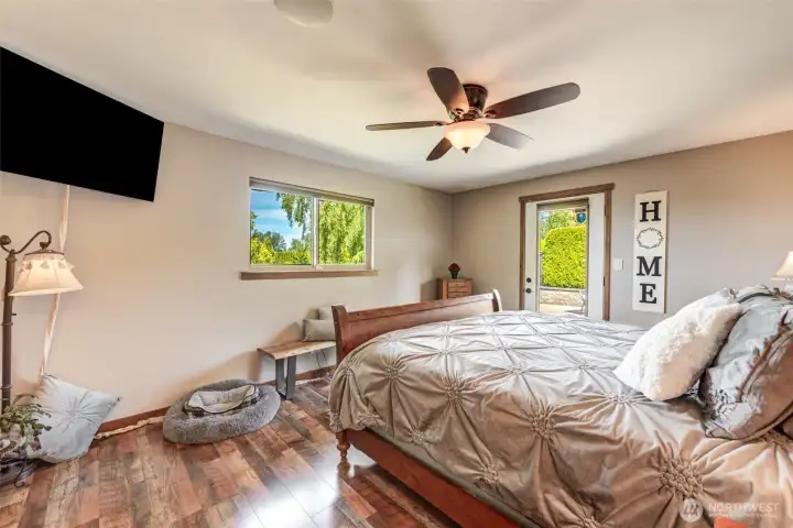 Wake up to beautiful greenery views from this inviting primary bedroom sanctuary.