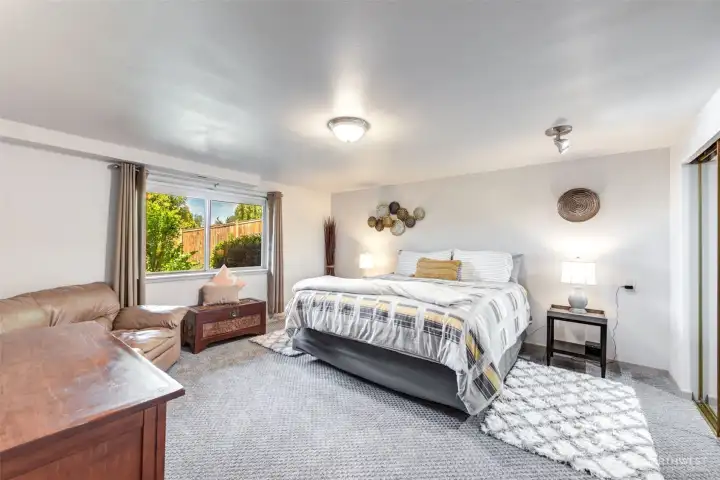 Part of the lower-level living suite, this spacious bedroom offers comfort, privacy, and flexible sleeping arrangements.
