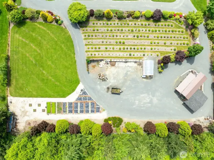 Explore the far end of the estate where you’ll find an established Christmas tree field, a third dedicated gardening area, greenhouse, additional storage shed, covered RV parking, and expansive space for equipment, trailers, recreational vehicles, or future hobby projects.