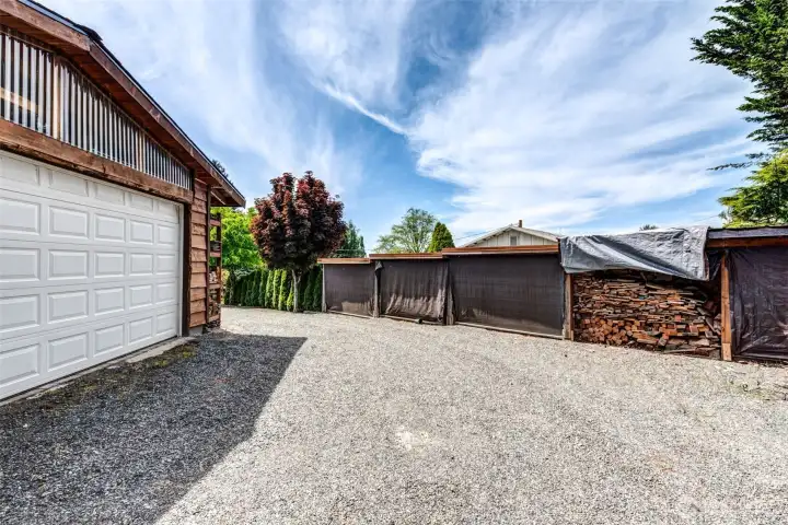 40’ x 40’ detached shop with extensive covered storage space, currently utilized for firewood and equipment storage.