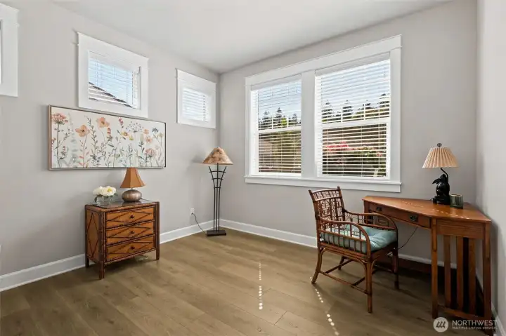Every good floorplan needs a guest wing, and this home delivers one beautifully. Located just off the foyer, this spacious front bedroom enjoys exceptional privacy thanks to a thoughtful layout where no bedroom shares a wall with another bedroom. The nearby full bathroom creates a convenient setup for guests, extended family or anyone who appreciates having their own little corner of the home. Measuring approximately 11' x 11.5', the room offers space for a queen bed, office furniture or a creative hobby setup, while the closet provides plenty of storage.
