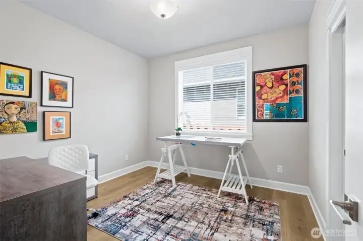 Flexibility is one of the hallmarks of a great floorplan, and this versatile den delivers exactly that. Measuring approximately 10.5' x 11', the space works beautifully as a home office, reading room, hobby space or an additional bedroom when needed. A generously sized closet expands its functionality, making it easy to adapt as your needs change over time. The warm wide-plank flooring continues seamlessly into the room, maintaining the cohesive design found throughout the home, while natural light helps create a bright and welcoming atmosphere. Whether you're working remotely, hosting overnight guests or finally creating that craft room you've always wanted, this space is ready to step into the role.