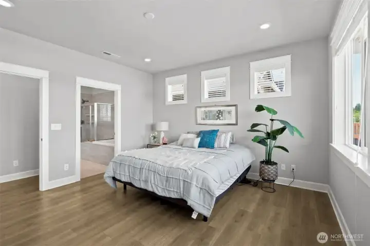 This room is large enough to comfortably fit a king-size bedroom set, multiple dressers and still leave space for a reading nook, hobby corner or small home office setup. From this angle, you can see the seamless connection to the private en suite bath, reinforcing the feeling of having your own retreat tucked away from the rest of the home. The proportions are generous creating a comfortable balance that allows the room to evolve with your needs over time. Add in those spectacular Mount Rainier views and suddenly this becomes a room you may find yourself lingering in a little longer each morning.