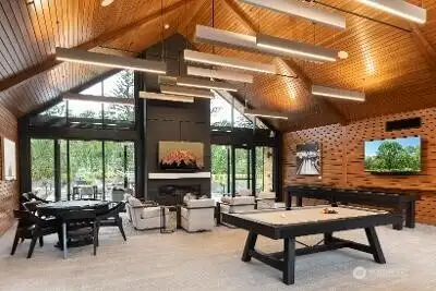 This is where Ovation at Oak Tree really starts showing off. Equal parts mountain lodge and modern clubhouse, this stunning gathering space features soaring wood-planked vaulted ceilings, a massive floor-to-ceiling fireplace and an entire wall of windows that brings the outdoors in. Multiple glass doors open to the patio, making the space feel even larger when community events and gatherings spill outside. Whether you're attending a class, meeting friends for a game of ping-pong, enjoying one of the many social events or simply curling up near the fireplace with a good book, this clubhouse delivers the lifestyle buyers are looking for when they choose a premier 55+ community. It feels less like an amenity and more like an extension of your home.