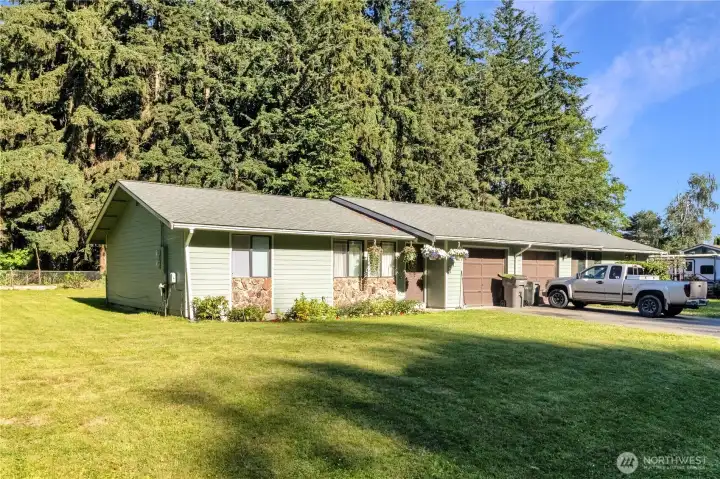 Side view highlighting the large lot and tenant-maintained landscaping.