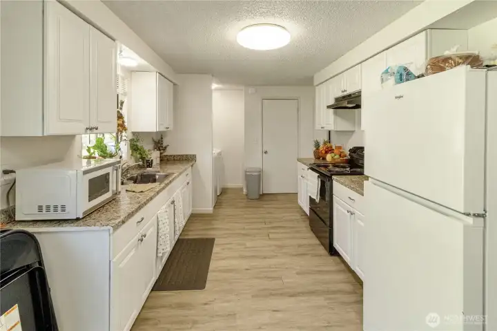 Unit A kitchen with ample cabinet space and functional layout.
