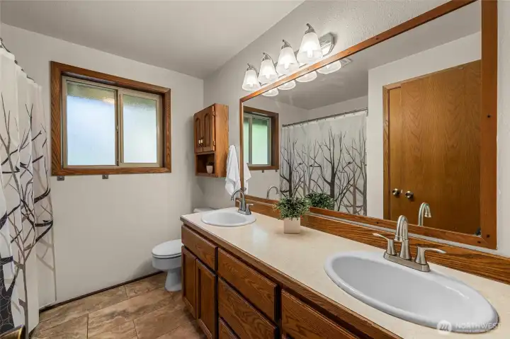 Hall bathroom with dual vanity and bathtub shower combo Hall bathroom with dual vanity and bathtub shower combo