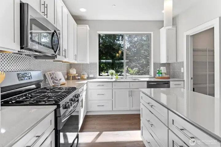 Gas cooking, stainless appliances, and extensive cabinetry make this kitchen as functional as it is beautiful with plenty of storage space. Gas cooking, stainless appliances, and extensive cabinetry make this kitchen as functional as it is beautiful with plenty of storage space.