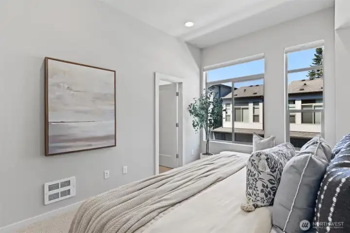 Private primary suite featuring tall ceilings and a peaceful outlook. Private primary suite featuring tall ceilings and a peaceful outlook.