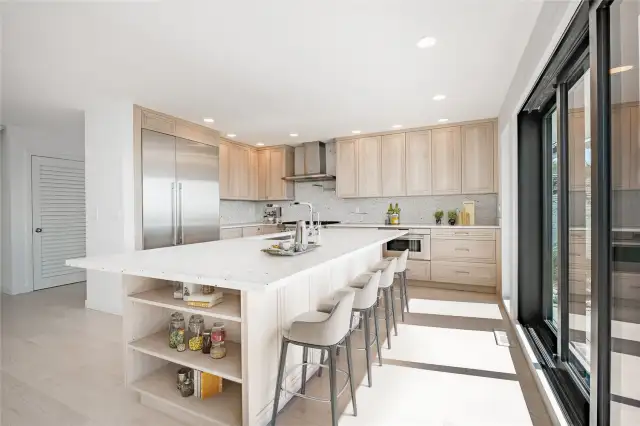 Solid slab granite & backsplash, seating up to 5 at eat-in bar, built in storage around island