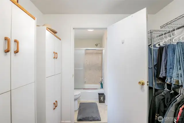 Primary closet and door to bathroom