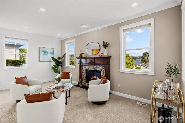 A sitting room off the kitchen with a gas fireplace is a perfect conversational hub providing a warm and inviting atmosphere.