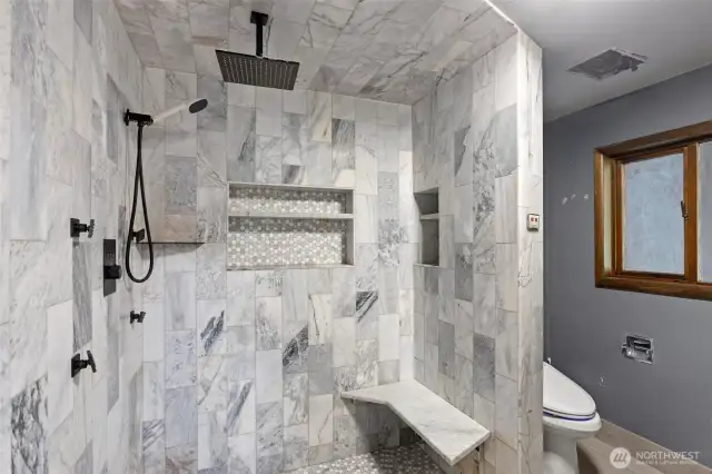 Large walk in shower in bathroom.