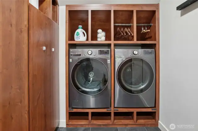 Laundry/dog wash area off the garage with so much storage.