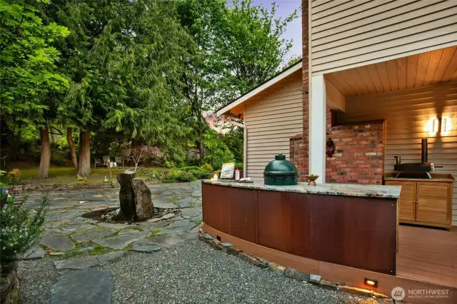 Corten steel accents with a built-in Green Egg adjacent to your own living herb garden.