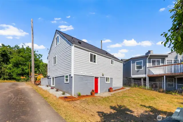 Back of home, yard access through basement.