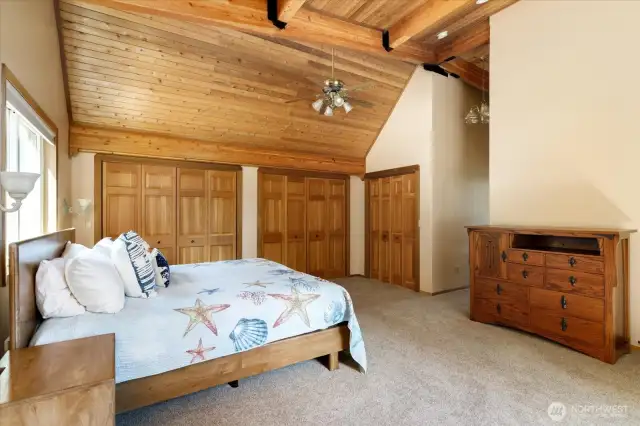 Loads of storage space with a wall of closets and walk in closet combined.