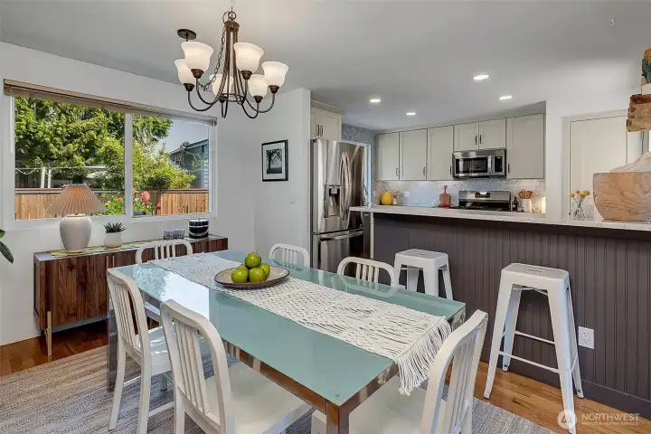 The dining area easily accommodates a Thanksgiving crowd or an intimate dinner party with friends. Large windows look out to the built-in garden beds ready for your flower garden or veggie patch.