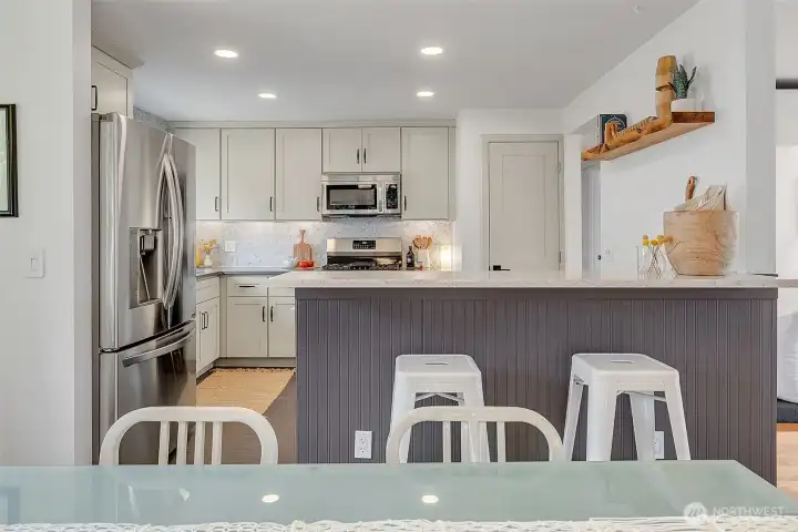 Updated kitchen with breakfast bar, can lights, under-cabinet lighting, AND a large pantry for all your culinary supplies.