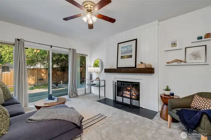 The family room with tons of light, wood wood-burning fireplace, and slider access to the patio and fully fenced back yard.