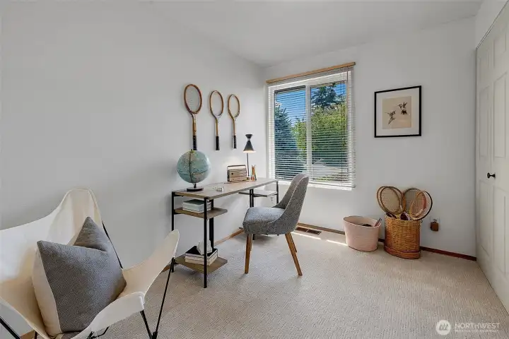 One of 3 bedrooms off the main hallway with a large closet and new carpet. There are oak hardwood floors under the carpet.