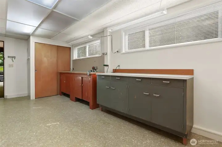 An efficient utility suite, offering abundant storage with space for hobbies and room for gear, with an easy entrance to the carport.