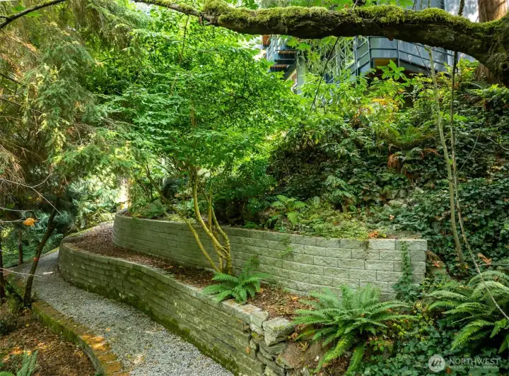 Terraced landscaping designed with artistry and intention: native planting enhance beauty while engineered retaining walls provide lasting strength.