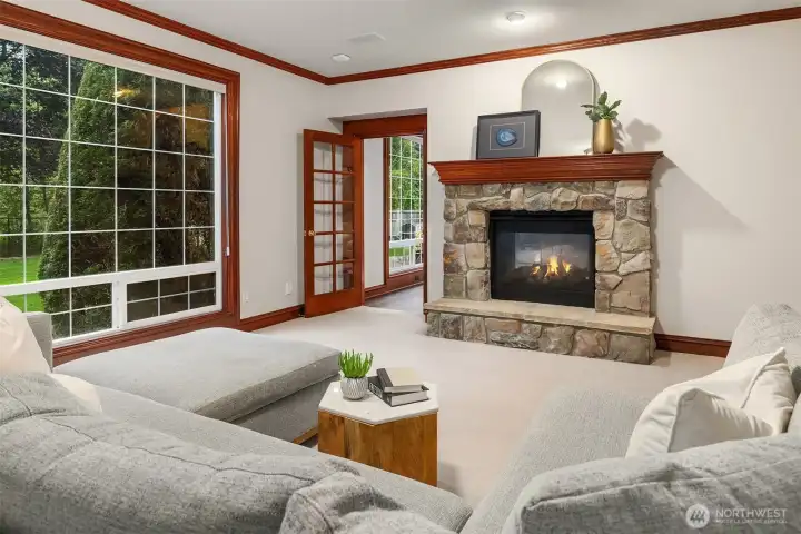 Main level bonus room with a stone surround fireplace off the family room. This space could be an additional work from home space, playroom or 5th bedroom/guest suite.