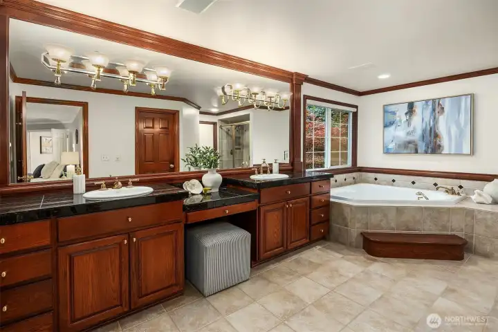 The primary ensuite features dual walk-in closets, a Jacuzzi spa tub with jets and tile flooring.