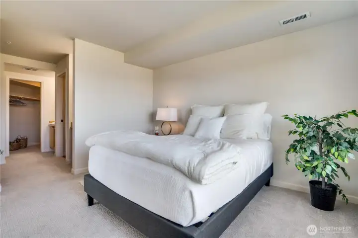 New carpet and fresh paint give the primary suite a clean, modern feel—ready for your personal touch.