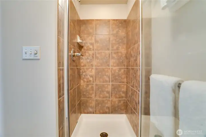 The elegant shower is both stylish and practical, completing the spa-like feel of the primary bath.
