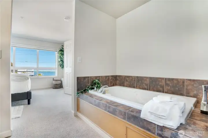 One last look at the jetted tub and stunning view as we leave the primary suite—but don’t worry, every window in this home offers a breathtaking scene.