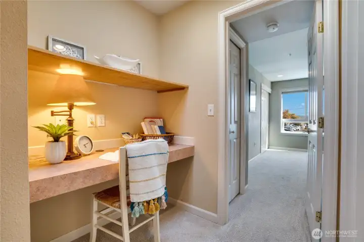 A cozy office nook beneath a skylight is the perfect place to work, read, or create in a bright and welcoming space.
