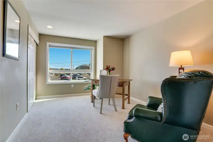 The second bedroom features new carpet, a large window for natural light, and a spacious closet.