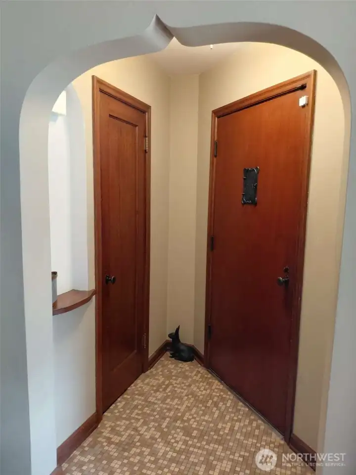 The front entry has a fun niche, which is a great place to set your keys or a pop of color with a beautiful bouquet picked up from a recent visit to the Proctor Farmer's Market.  The tile floor is easy to clean if perchance your shoes are wet from rain, and the coat closet keeps the entry way clutter free. And how fun is that arched entry?