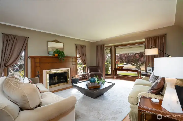 Leaded glass windows and a big, beautiful bay picture window grace this stately, yet charming, living room.