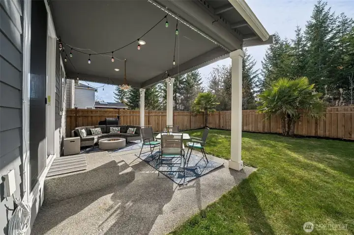 View of the back yard with covered patio