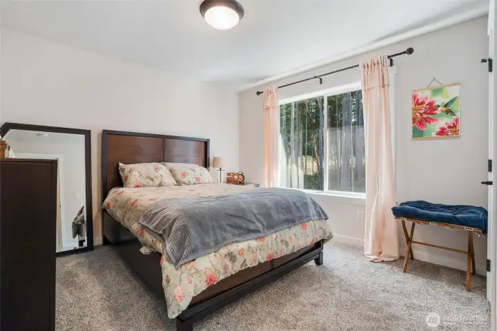 3rd bedroom with walk-in closet and wooded view.
