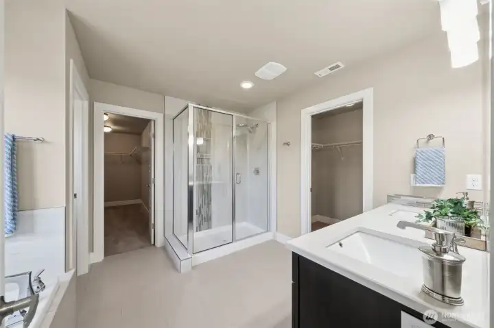 Primary Bathroom With Soaking Tub and Two Walk-In Closets