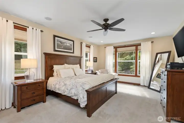 Primary bedroom with ceiling fan and wonderful natural light.