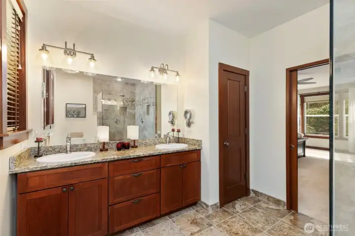 Primary bathroom with dual sinks and gorgous tile walk in shower.