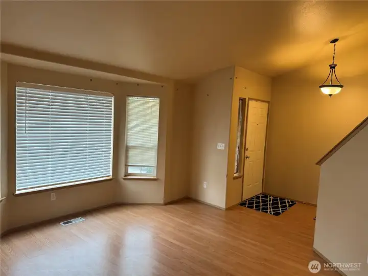 Living Room features Vaulted Ceilings, Bay Window and Main Entry nearby.