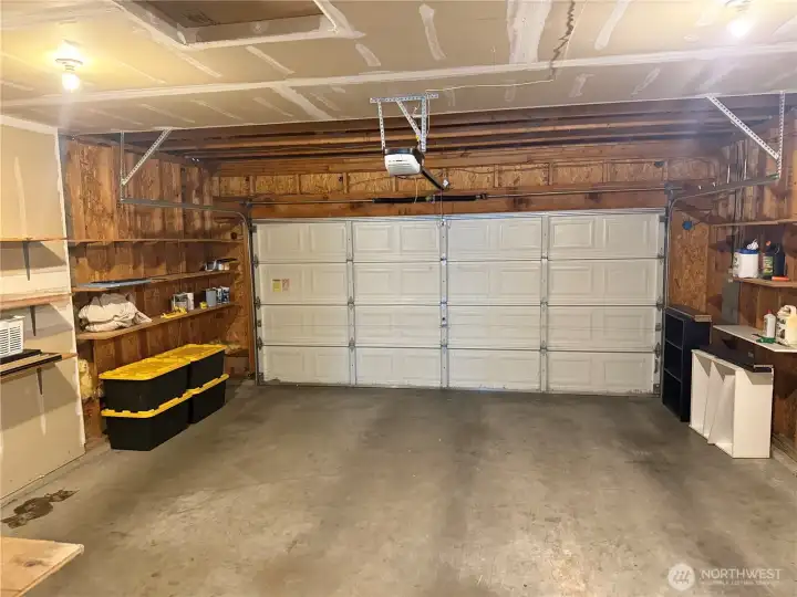 Inside view of the 2 Car Attached Garage. Has plenty of shelved for storage.