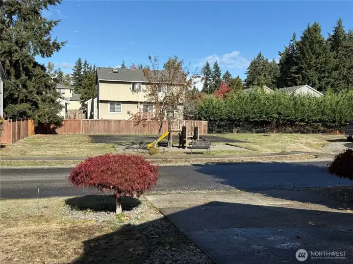 Nice Community Park with Playground  Equipment and Basketball court, conveniently located directly across the street from this home in a Low Traffic Culdesac. This photo was taken while standing on the Front porch.