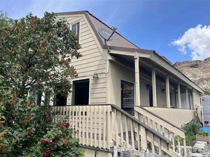 Rear side of the house. Wrap around covered deck.