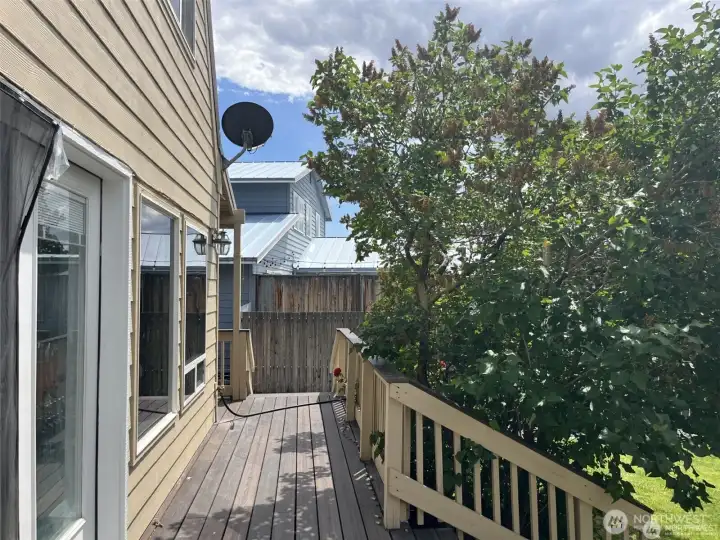 Deck continues to the side of the house and driveway.