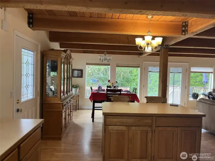 Looking towards the dining room from the kitchen. Look at all the back wall windows! Home is empty now with no furniture.